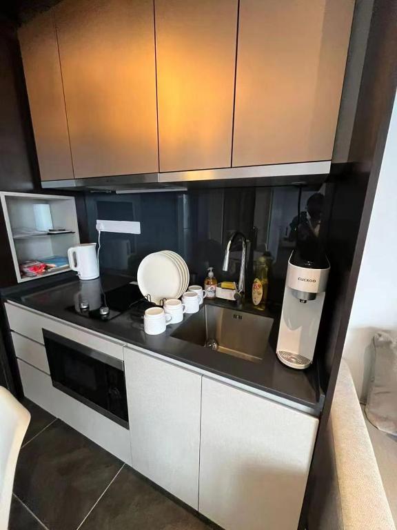 a kitchen with a sink and a counter top at Borderless Swimming Pool - Invincible Twin Towers View - Free WiFi in Kampong Gombak Utara
