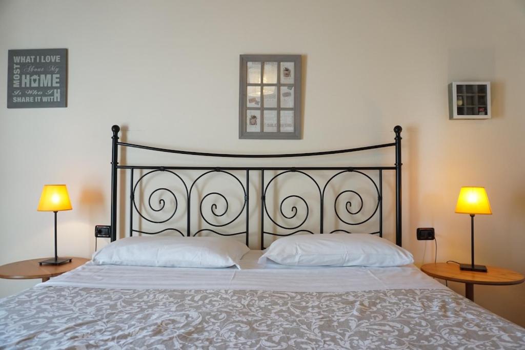 a bedroom with a large bed with two lamps on tables at Agriturismo La Fattoria Del Boschetto in Fontanellato