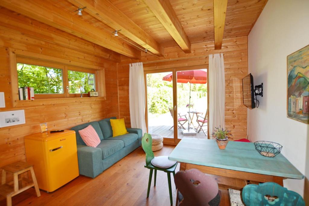 a living room with a couch and a table at Augenweide in Prien am Chiemsee
