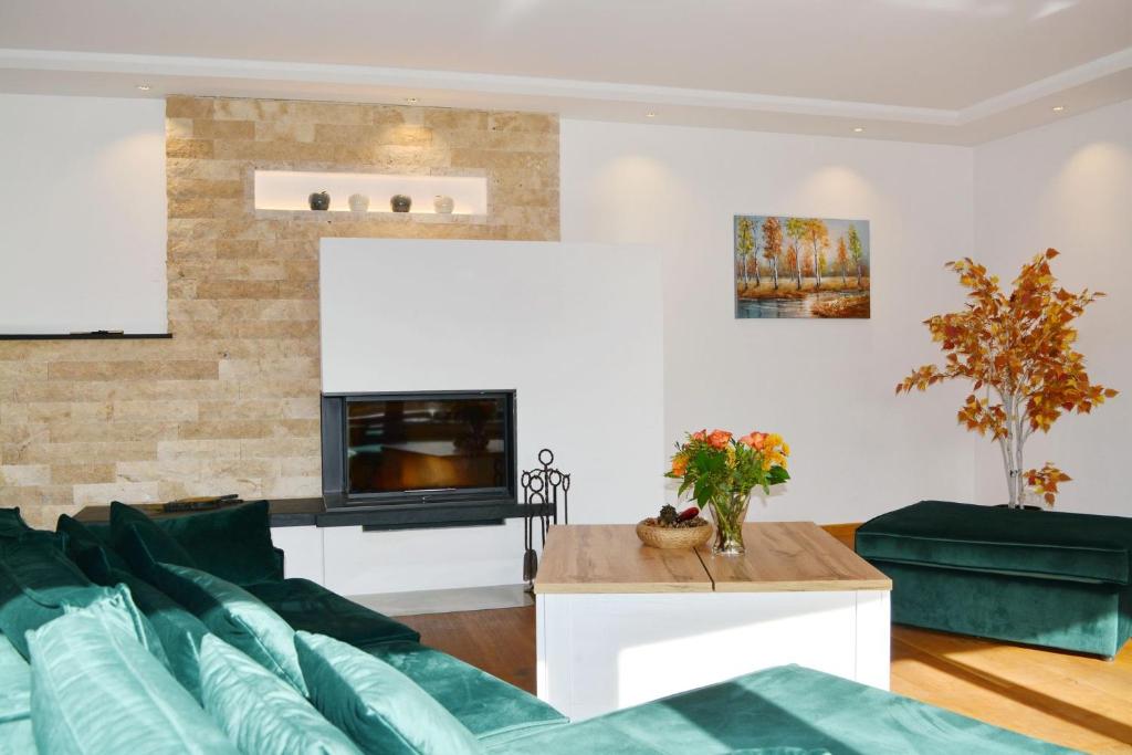 a living room with a couch and a fireplace at ChiemseeZeit in Gstadt am Chiemsee