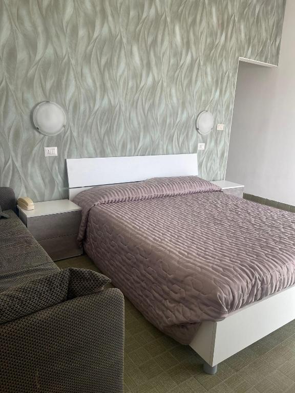 Postel nebo postele na pokoji v ubytování Hotel Re Leone