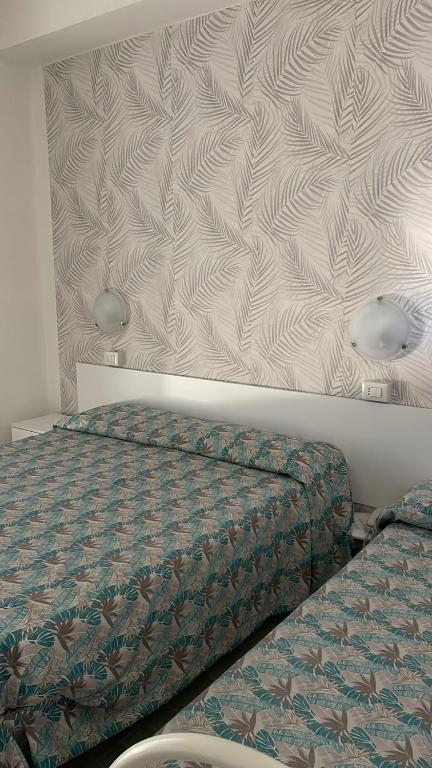 Postel nebo postele na pokoji v ubytování Hotel Re Leone