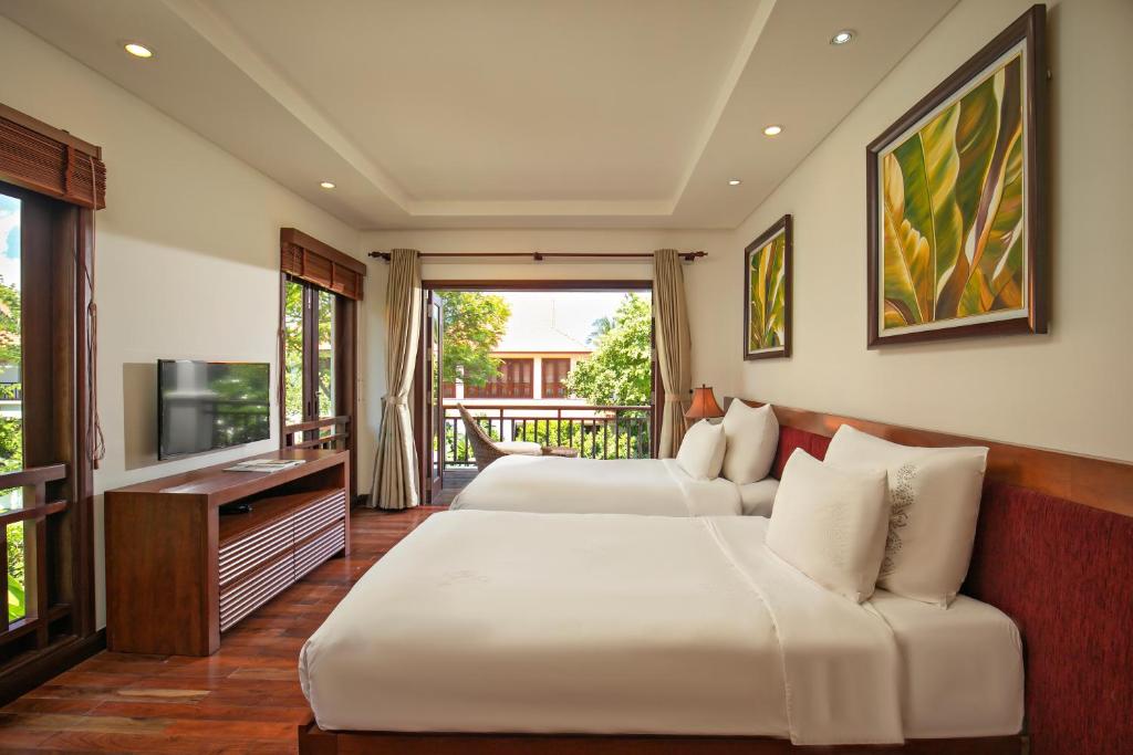 Postel nebo postele na pokoji v ubytování Da Nang Beach Villa Resort