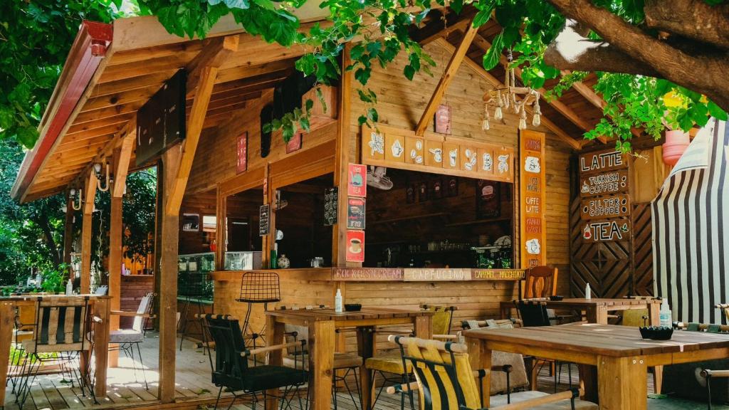 a restaurant with tables and chairs in front of it at Sheriff, Olympos in Kumluca