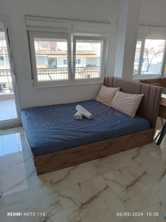 a bed with a teddy bear on it in a room at Zara's Boutique near Venizelos metro station in Thessaloniki