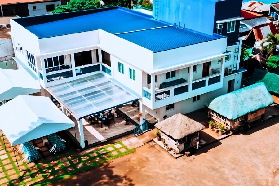 an overhead view of a white house with a blue roof at Hip Nautic Beach Resort powered by Cocotel in Lian