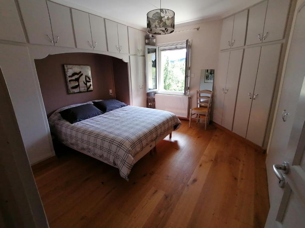 - une chambre avec un lit et une fenêtre dans l'établissement Appartement au calme près du lac d'Annecy, à Saint-Jorioz