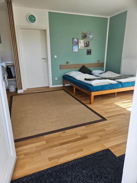 a room with two beds and a rug at Fewo Schwäbische Eisenbahn in Meckenbeuren