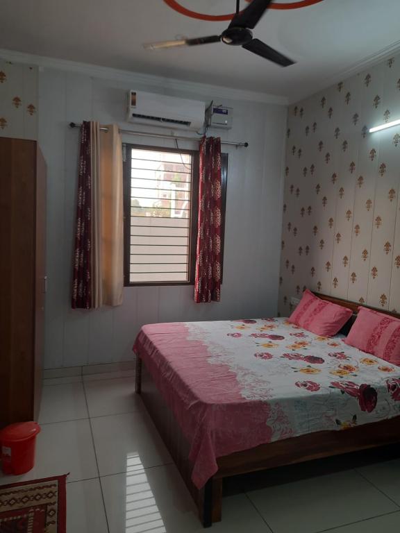 a bedroom with a bed and a ceiling fan at Ganpati Villa in Dehradun