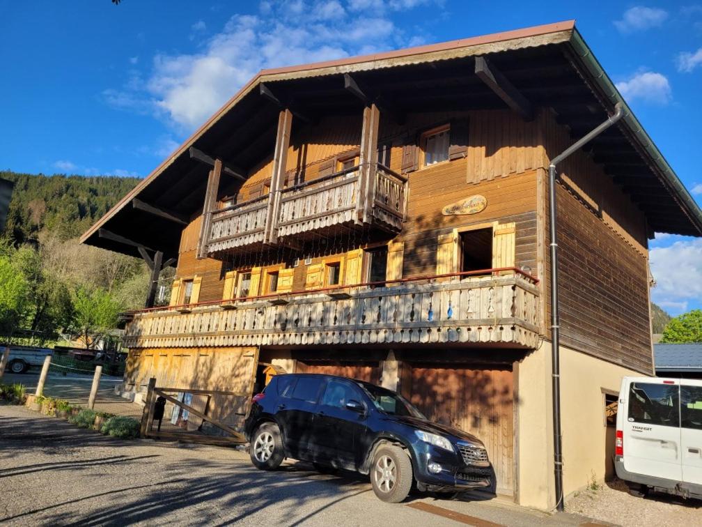 un camion noir garé devant un bâtiment dans l'établissement Chalet familial authentique et spacieux 2 chambres 4 à 6 personnes avec parking proche des remontées, à La Chapelle-dʼAbondance
