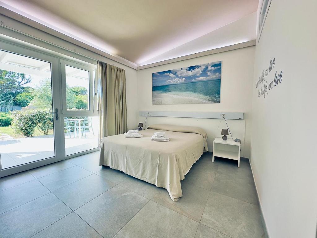 Кровать или кровати в номере 309 Le Saline - Stintino