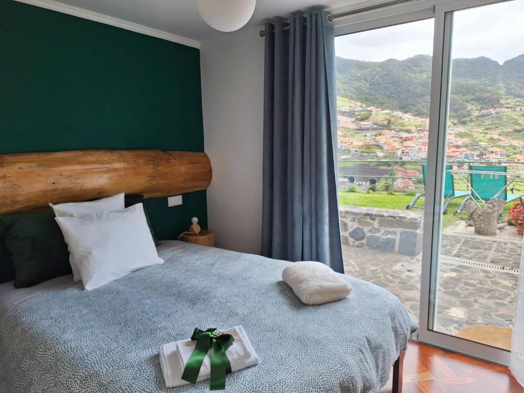 a bedroom with a bed with a christmas bow on it at Vale dos Ilhéus in Machico