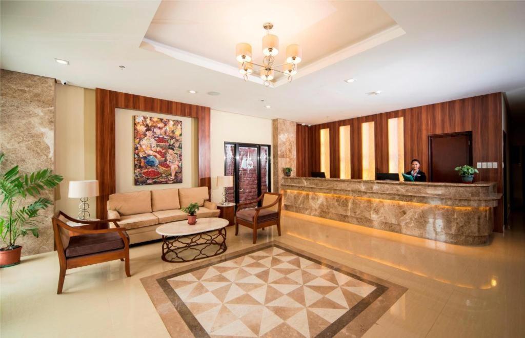 a lobby with a person sitting in a waiting room at V Hotel and Apartel in Baguio