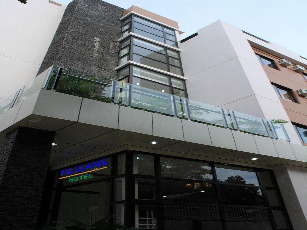 un bâtiment avec un balcon au-dessus dans l'établissement Filigans Hotel, à Puerto Princesa