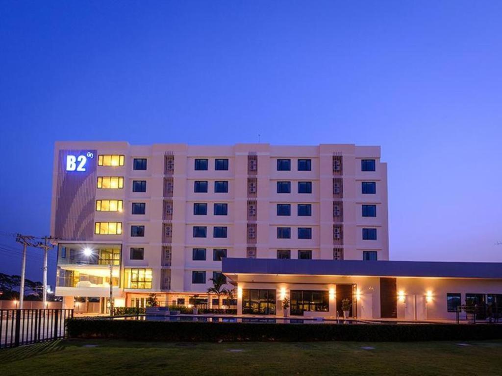 um grande edifício de hotel com luzes acesas à noite em B2 Korat Premier Hotel em Ban Liap