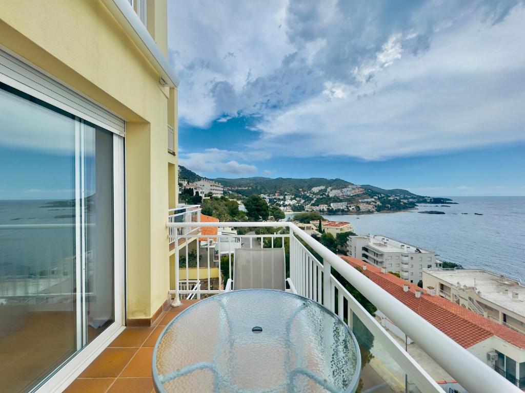 balcón con mesa y vistas al océano en Marina 4, en Roses