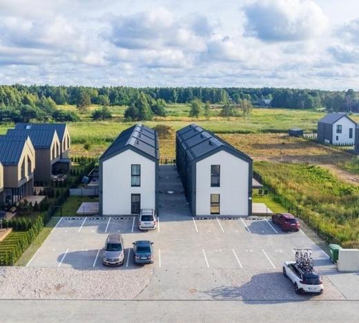 an aerial view of a parking lot with houses and cars at Genio apartamentai Kunigiskiuose in Palanga
