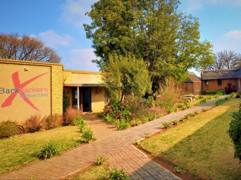 a building with a sign on the side of it at Johannesburg Airport Hostel in Benoni
