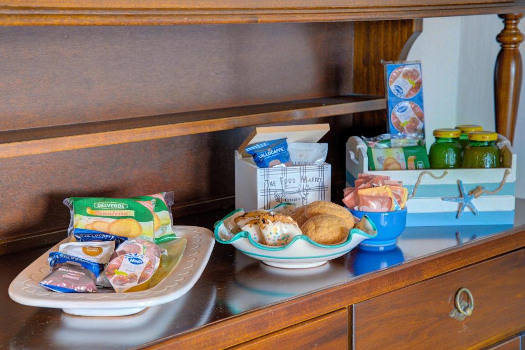 a shelf with two plates of food and other snacks at VILLA MARIA - CAPO D'ORSO - HOME and MORE in Palau