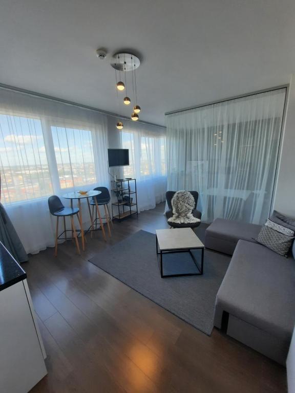 a living room with a couch and a table at Klaipėda city panoramic view in Klaipėda