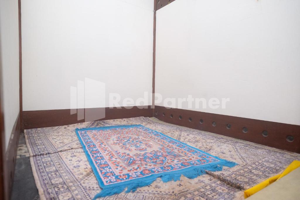 Postel nebo postele na pokoji v ubytování Tatti Inn Syariah Seturan RedPartner