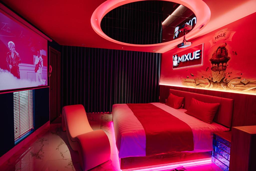 a red room with a bed and a mirror at Chiic House 6 - Khách sạn tình yêu in Vung Tau