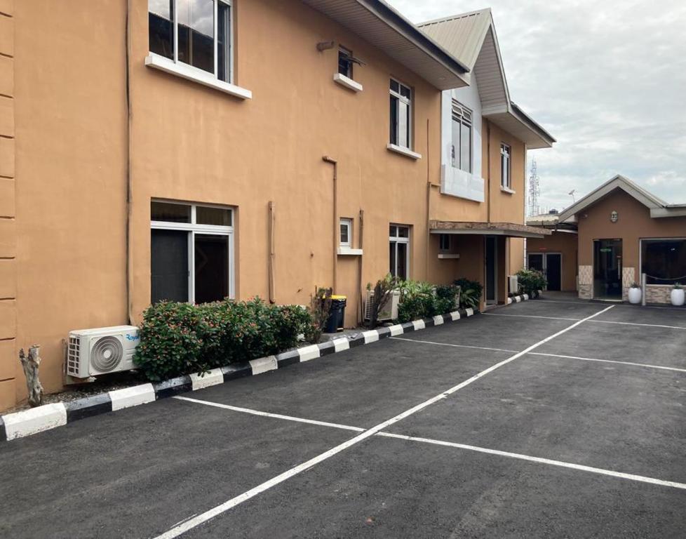 a parking lot in front of a building at TRENDY INN HOTEL in Lagos