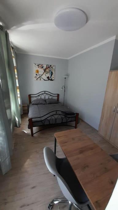 a room with a table and a bed and a table and chairs at Apartment Vecliepaja in Liepāja