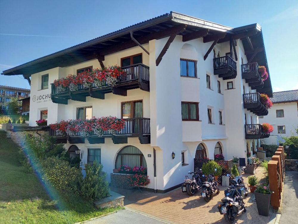 a building with motorcycles parked in front of it at Jochum Hotel Garni in Fiss