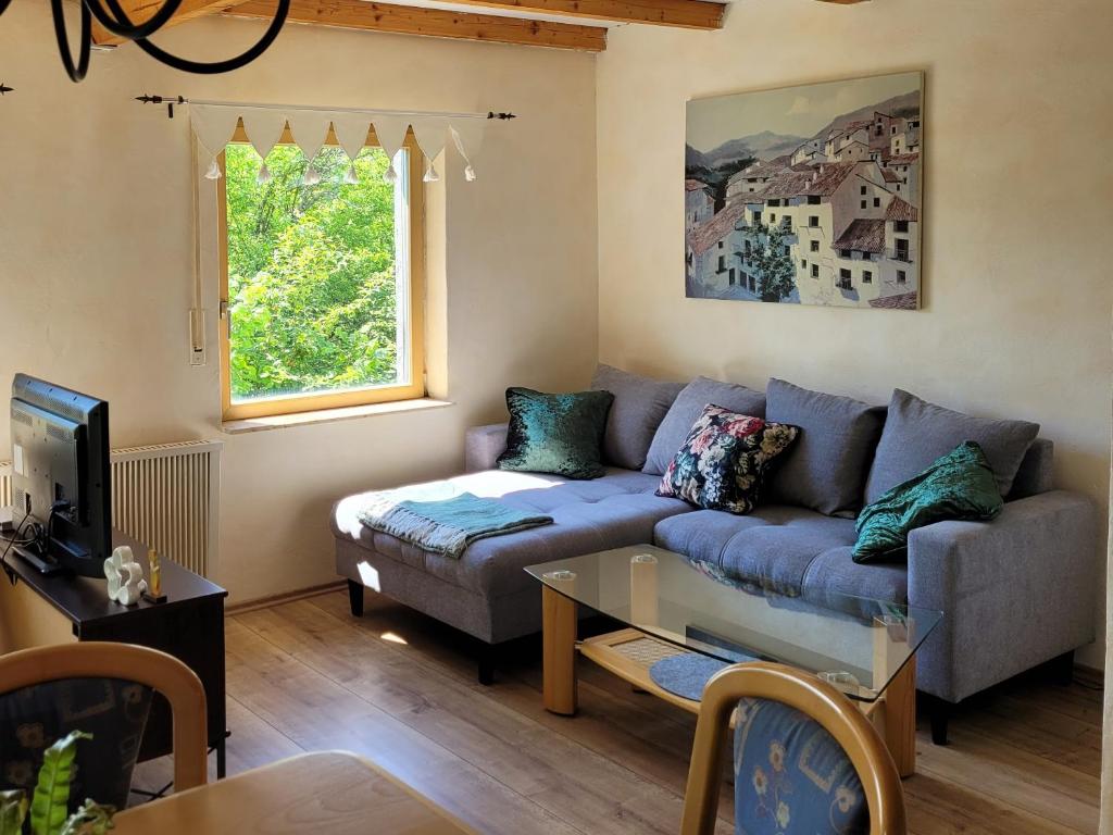 a living room with a couch and a table at Ferienwohnung im Haus Waldblick in Nonnweiler