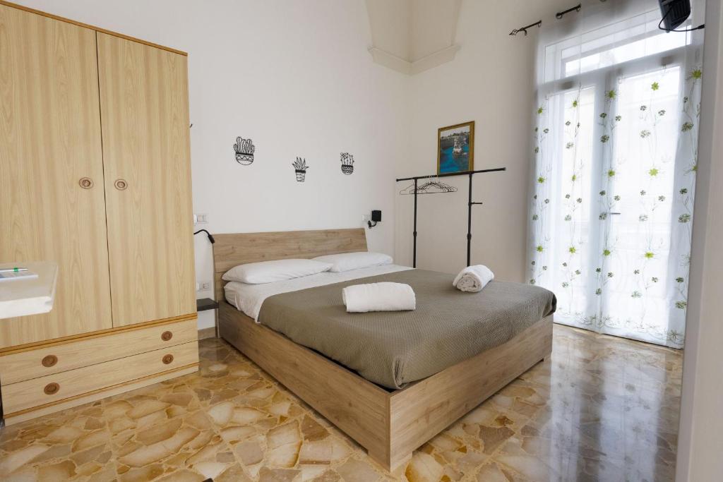 Postel nebo postele na pokoji v ubytování A7passi Gran stella leccese " stanzA ingresso indipendente "