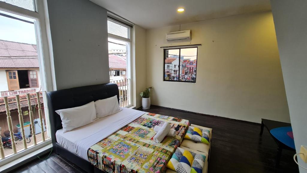Postel nebo postele na pokoji v ubytování Jade Guesthouse Jonker Melaka