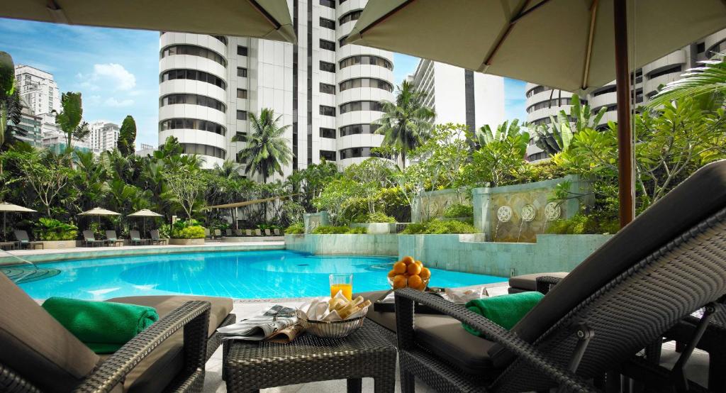 a resort with a swimming pool and a building at Shangri-La Kuala Lumpur in Kuala Lumpur