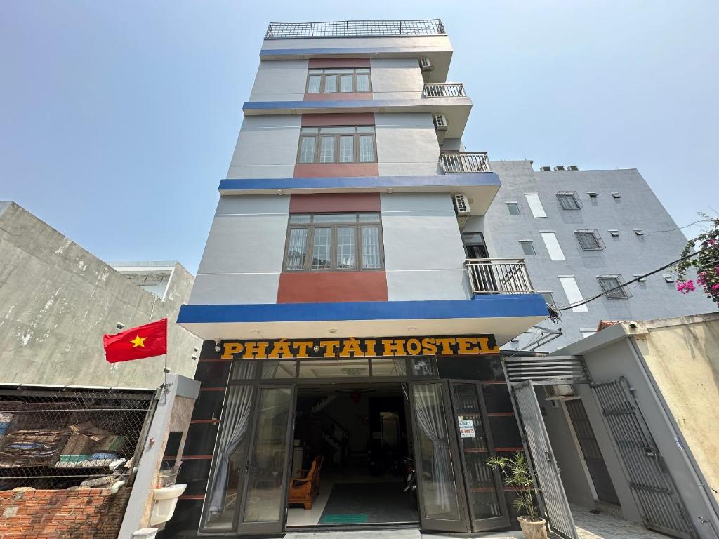 a tall building with a sign in front of it at OYO 1064 Phat Tai Hotel And Apartment in Da Nang