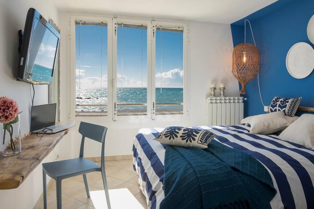 a bedroom with a bed and a desk and a television at fronte mare spiaggia - marine 59 in Diano Marina