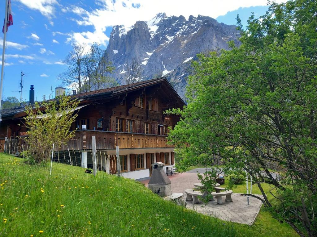 a building with a mountain in the background at Chalet Pfyffer - Mountain view in Grindelwald