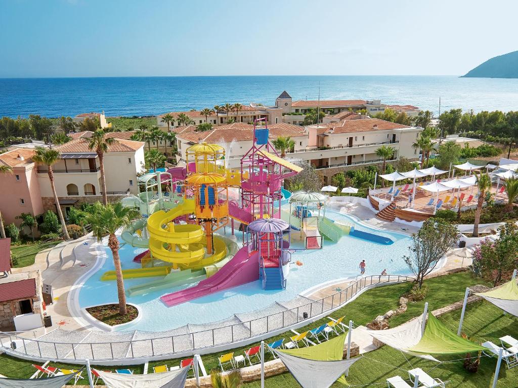 an aerial view of a water park with a water slide at Grecotel Marine Palace & Aqua Park in Panormos Rethymno
