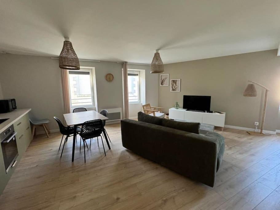 a living room with a couch and a table at Appartement duplex 4-6 personnes in Cerizay
