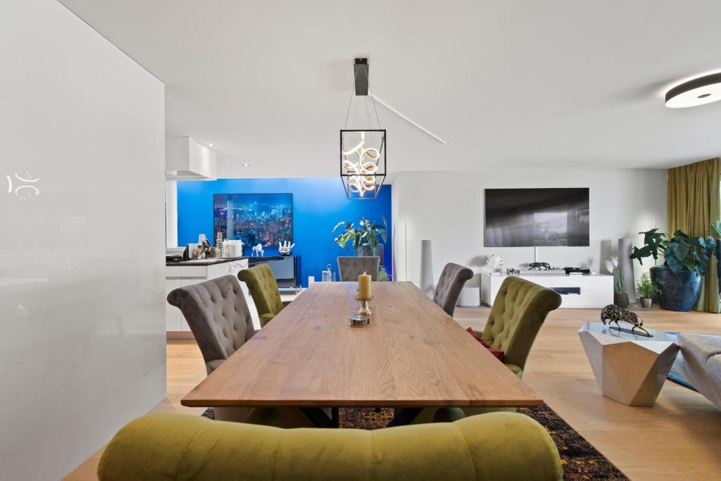 a dining room with a wooden table and chairs at Exclusive spacious Apt. with garden in Zurich in Zürich