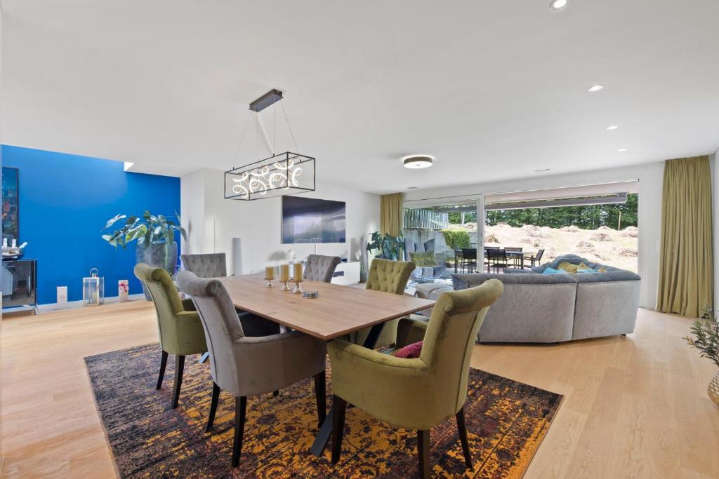 a dining room and living room with a table and chairs at Exclusive spacious Apt. with garden in Zurich in Zürich