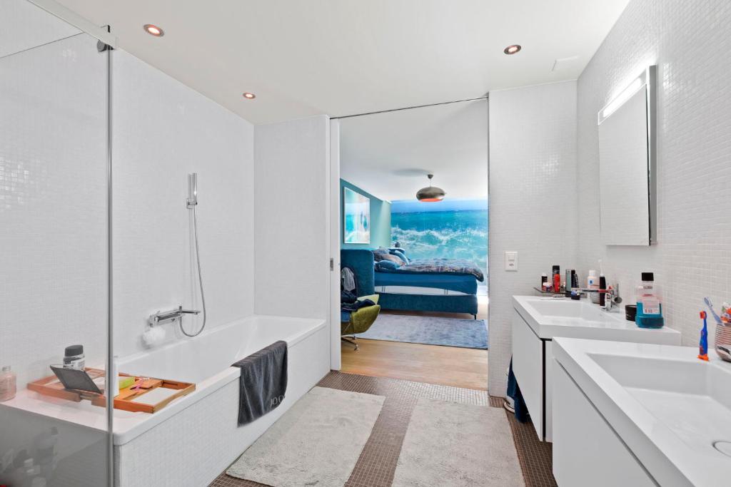 a bathroom with two sinks and a large mirror at Exclusive spacious Apt. with garden in Zurich in Zürich