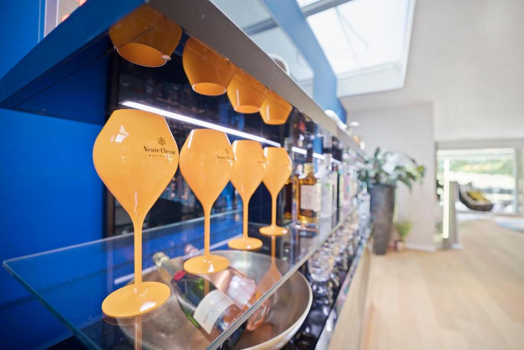 a row of yellow utensils on a shelf in a store at Exclusive spacious Apt. with garden in Zurich in Zürich