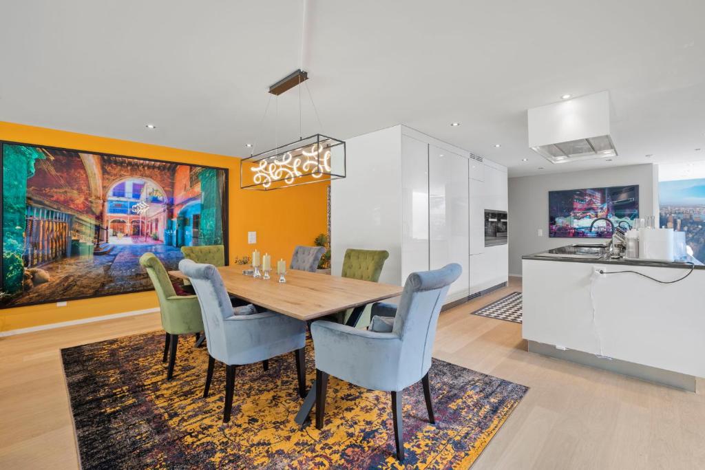 a dining room with a table and chairs and a kitchen at Exclusive spacious Apt. with garden in Zurich in Zürich