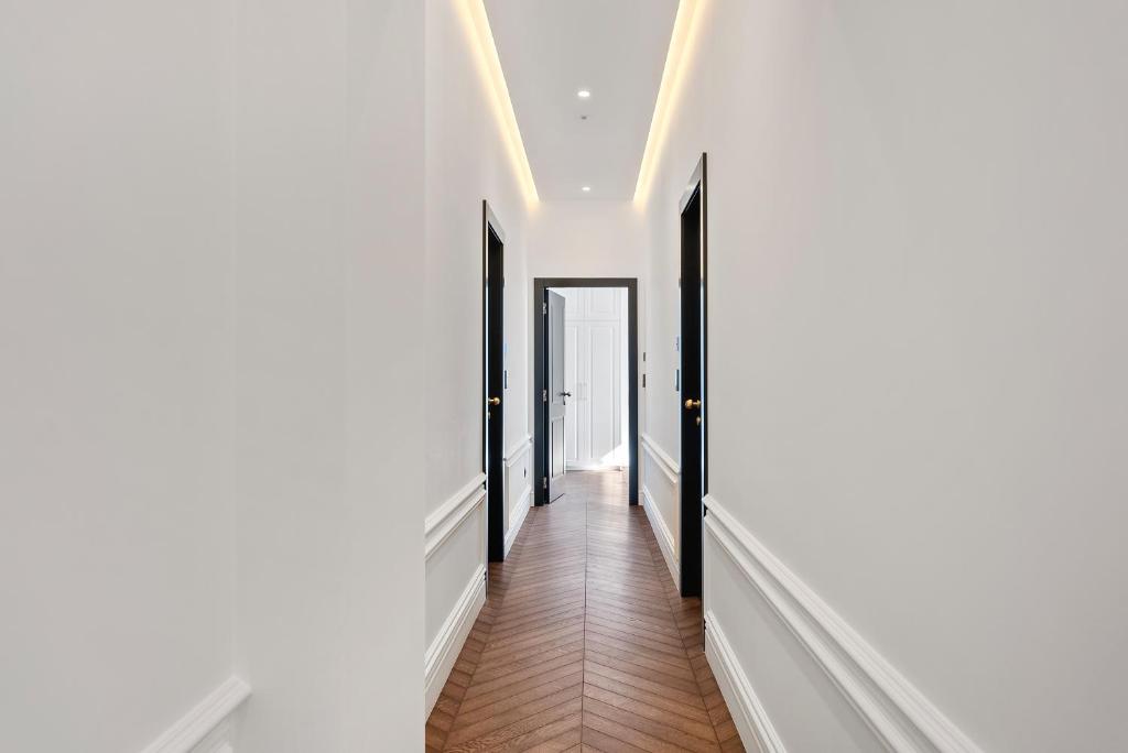 a hallway with black and white walls and wood floors at 1881 - Heritage rooms in Split