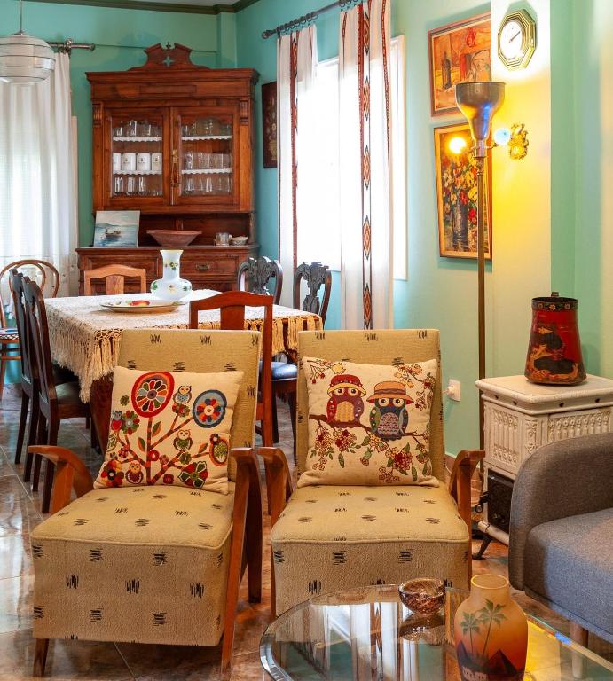 a living room with two chairs and a table at Stavros summer house in Nea Fokea
