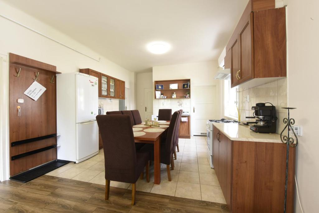 a kitchen with a table and chairs in a room at Milán Apartment in Nyíregyháza