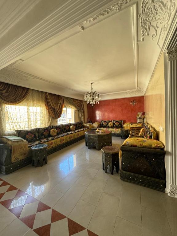 a large living room with couches and a chandelier at Luxury duplex in the centre of Maarif in Casablanca