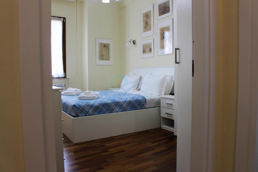 a bedroom with a bed with a blue comforter at Your Perfect Roman Getaway in Vatican in Rome