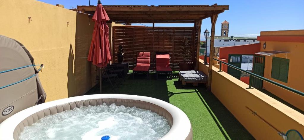 a large tub of water on the balcony of a building at OkStay Casa Maye Tenerife with jacuzzi and large outdoor area in Güimar
