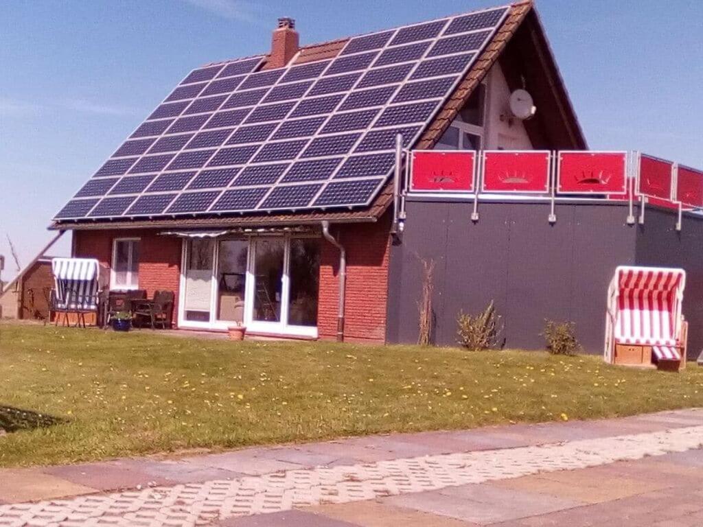 a house with solar panels on the roof at Nordzeeoase-Pethan met sauna in Neuharlingersiel